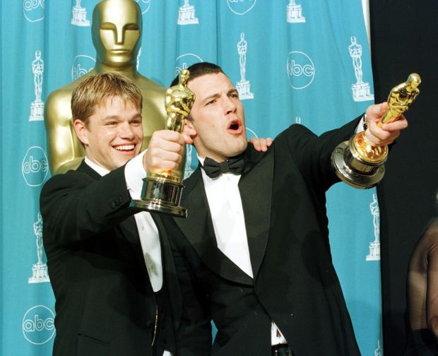 LOS ANGELES, CA - MARCH 23: Oscar winners Matt Damon (L) and Ben Affleck hold the awards they won for best original screenplay for the film "Good Will Hunting" which the two wrote during the 70th Annual Academy Awards 23 March in Los Angeles. (Photo credit should read HAL GARB/AFP/Getty Images)